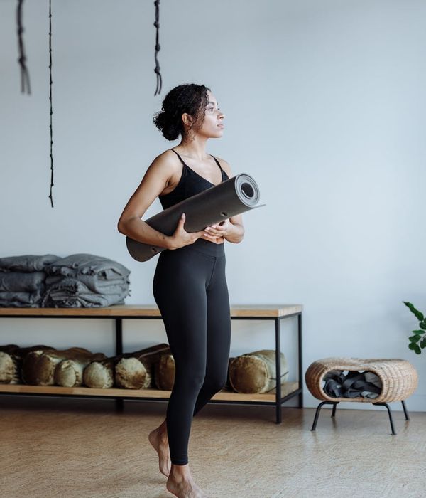 Woman practicing a calm yoga pose in a serene studio.